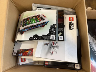 Lot 1072 - 4 boxes containing various Lego model manuals