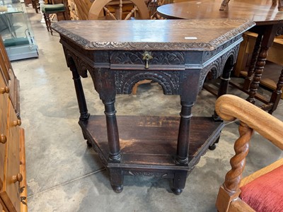Lot 1315 - Dark oak faceted single drawer 2 tier side table
