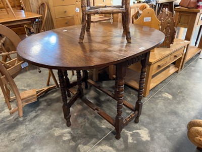 Lot 1316 - Dark oak barley twist ovel drop leaf dining table