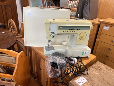 Lot 1329 - Singer electric powered sewing machine in hard...