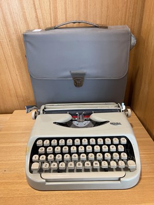 Lot 1334 - 3 cased portable typewriters, including a...