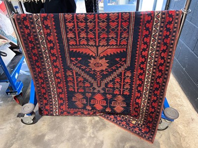 Lot 1478 - Blue and red geometric patterned woollen rug