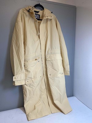 Lot 3780 - Diesel long length rain coat in beige size...