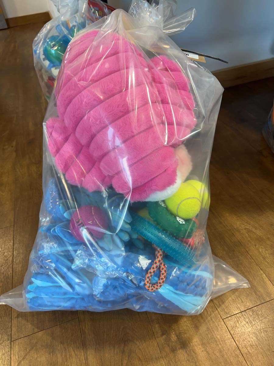 Lot 2276 - A bag containing a selection of dog toys