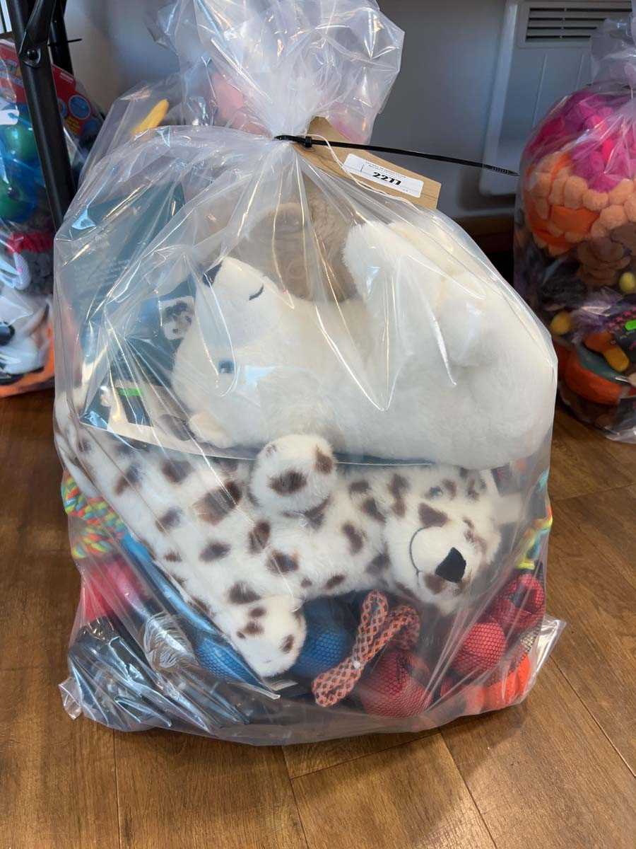 Lot 2277 - A bag containing a selection of dog toys