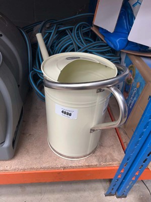 Lot 4096 - Metal watering can and a quantity of hosepipe