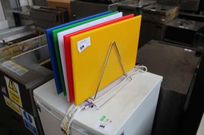 Lot 379 - 5 colour coded assorted chopping boards with rack