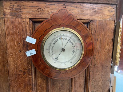 Lot 38 - An aneroid barometer in a mahogany and strung...