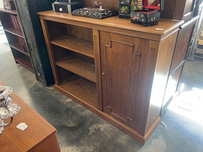 Lot 1040 - Dark oak open fronted bookcase with single...