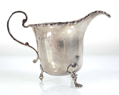 Lot 310 - A silver cream jug of typical form, Adie Bros.,...