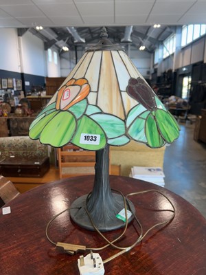Lot 1033 - Tiffany style table lamp on tree trunk shaped...