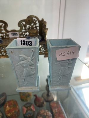 Lot 1303 - Pair of miniature light blue vases depicting...