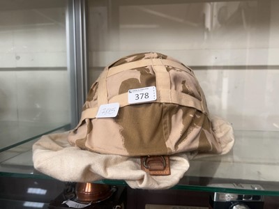 Lot 378 - A fabric covered military helmet with bag