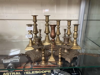 Lot 379 - Fourteen metal work candle sticks of assorted...
