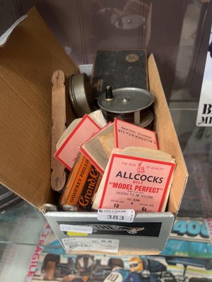 Lot 383 - Assorted fishing accessories to include reels,...