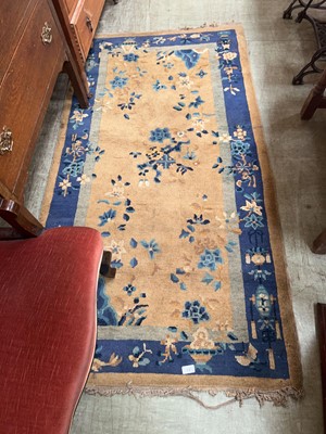 Lot 37 - An eastern style yellow ground wool rug