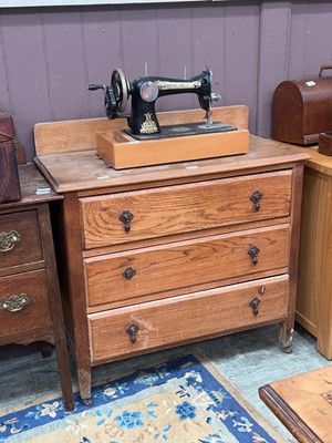 Lot 42 - A 20th century distressed oak chest of three...