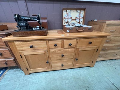 Lot 48 - A modern oak sideboard with six drawers and...