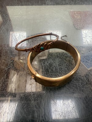 Lot 401 - Two rolled gold/yellow metal bangles, one...