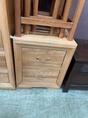 Lot 54 - A modern oak bedside chest of two drawers by...