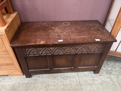 Lot 56 - A 20th century oak coffer with foliate carving...