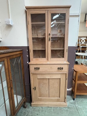 Lot 59 - A stripped pine full height bookcase, the top...