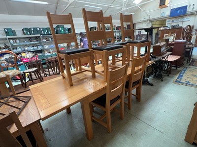 Lot 62 - A modern oak extending dining table along with...