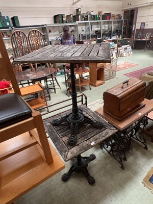 Lot 63 - A pair of cast metal based tilt top pub tables