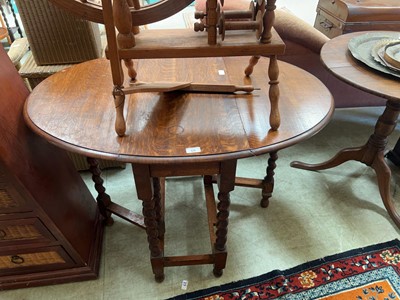 Lot 68 - An oak oval top gate leg dining table on...