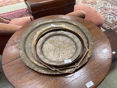 Lot 69 - Four eastern style embossed metalwork trays...