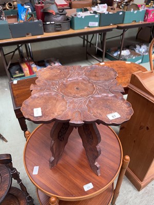 Lot 87 - A carved wooden table with foliate design in...