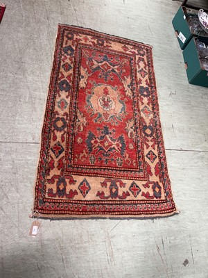 Lot 91 - An eastern style cream ground hand woven wool...