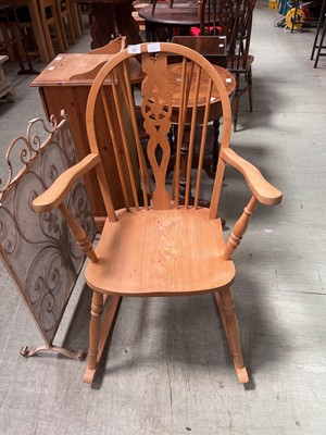 Lot 92 - A waxed pine wheel back rocking chair