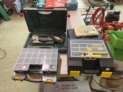 Lot 107 - A Cased Metabo jig saw along with three cases...
