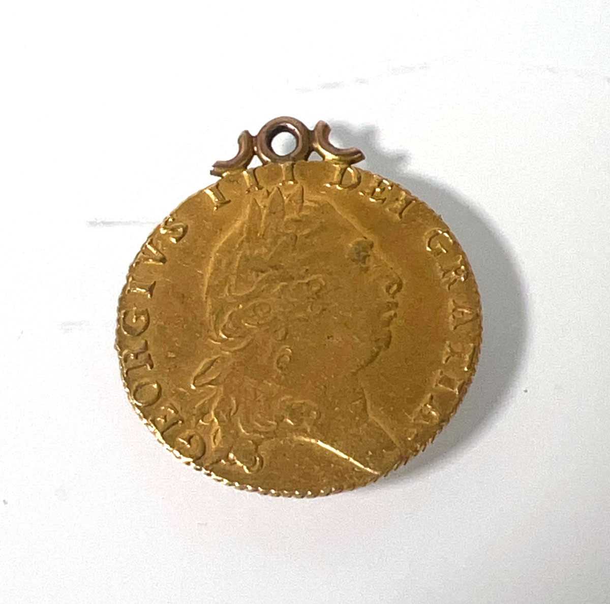 Lot 404 - A mounted George III gold 'Spade' Guinea dated...