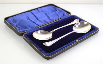 Lot 328 - A pair of silver serving spoons with scroll...