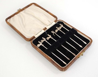 Lot 330 - A set of six silver cocktail picks, each with...