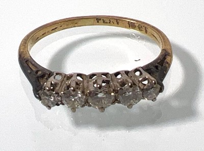 Lot 410 - A yellow metal and five stone diamond ring...