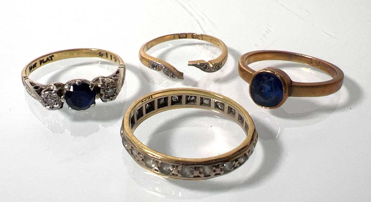 Lot 414 - A yellow metal, sapphire and diamond ring...