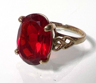 Lot 419 - A 9ct gold and garnet dress ring with openwork...