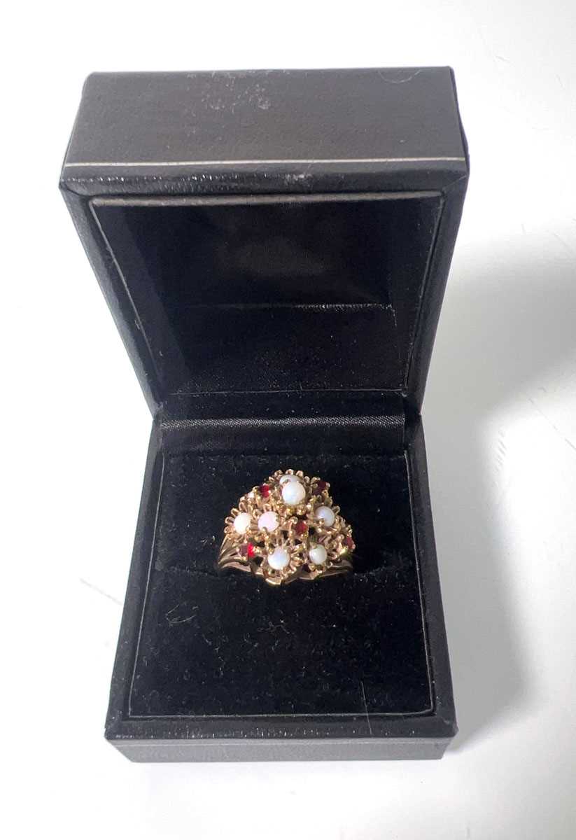Lot 420 - A 9ct gold, opal and garnet dress ring, the...