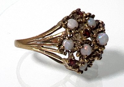 Lot 420 - A 9ct gold, opal and garnet dress ring, the...