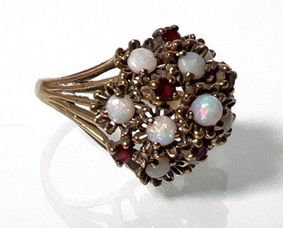 Lot 420 - A 9ct gold, opal and garnet dress ring, the...