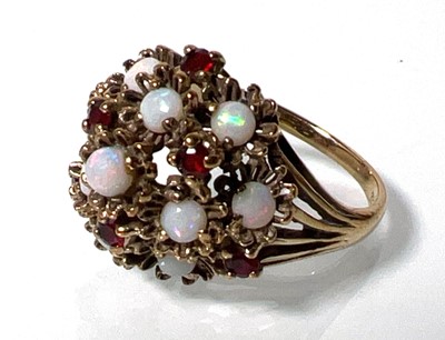 Lot 420 - A 9ct gold, opal and garnet dress ring, the...