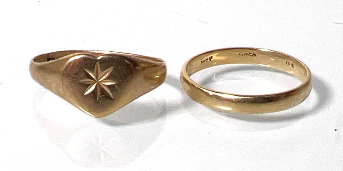 Lot 422 - Two yellow metal rings with indistinct marks....
