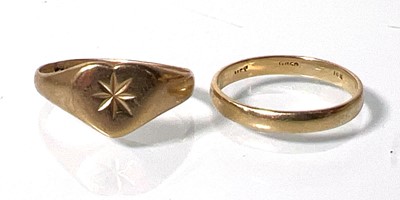 Lot 422 - Two yellow metal rings with indistinct marks....