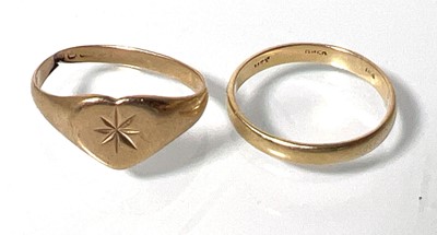 Lot 422 - Two yellow metal rings with indistinct marks....