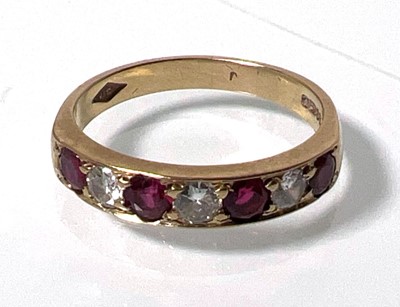 Lot 424 - A 9ct gold, garnet and diamond ring, the seven...