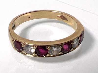 Lot 424 - A 9ct gold, garnet and diamond ring, the seven...