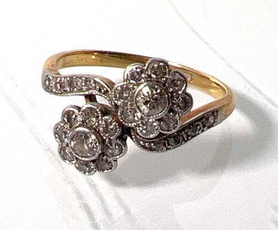 Lot 435 - A yellow metal and diamond crossover ring, the...